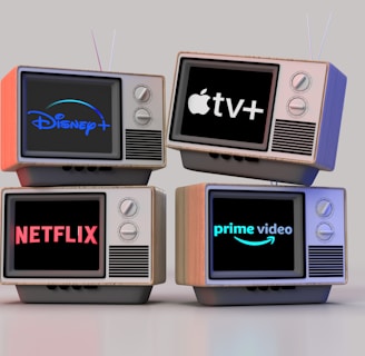 Four old-style television sets are stacked in two rows and each screen displays a different streaming service logo: Disney+, Apple TV+, Netflix, and Prime Video.